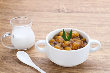 Bubur Ubi atau Jenang Telo is a dessert from Indonesia made of sweet potato, palm sugar and tapioca flour served with coconut milk.の写真素材