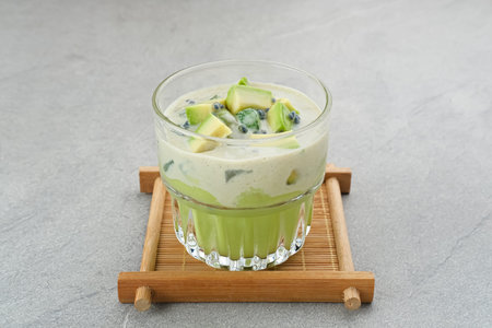 Avocado Milk Cheese Dessert is made from avocado, jelly, cheese, basil seeds, sweetened condensed milk and evaporated milk. Served in a glass. Space for textの写真素材