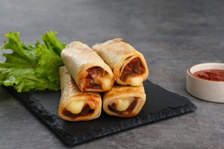 Spicy kebab with meat and mozzarella cheese served with lettuce and chilli sauce. Selective focus...