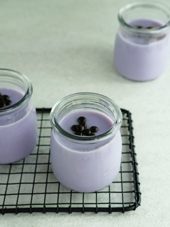 Silky pudding topped with chocochips. Served in a jar with a white background. Very fresh and...