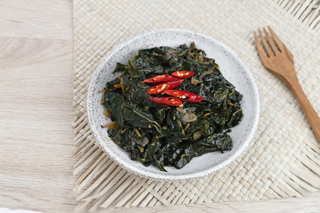 Stir Fry Papaya Leaves or Tumis Daun Pepaya, a traditional Indonesian dish made from boiled papaya...