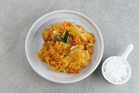 Sawut or Gobet Singkong, Indonesian traditional snack made from steamed shredded cassava, and palm sugar, served with grated coconutの写真素材