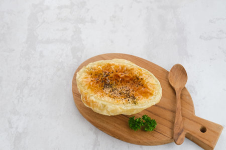 Zuppa Soup, a thick and creamy soup with puff pastry placed on top like a hat, contains corn,...