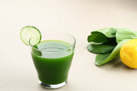 A glass of Green Juice, made from organic pakcoy, cucumber and lemon, very good for health. Cold Pressed Juiceの写真素材