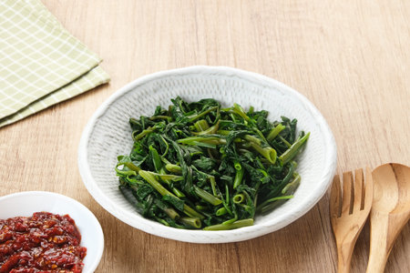 Plecing Kangkung or Brambang Asem, made from boiled spinach served with chili sauce (sambal), spicy...