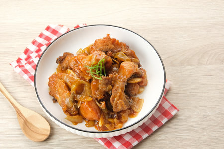 Ayam Goreng Mentega or Butter Chicken in white plate. Indonesian food.の写真素材