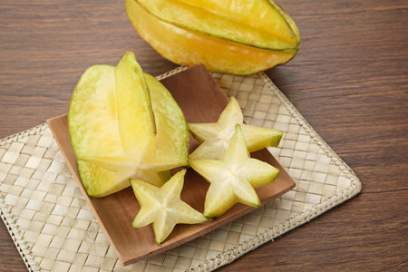 Belimbing or Starfruit (Averrhoa carambola) on wooden plateの写真素材