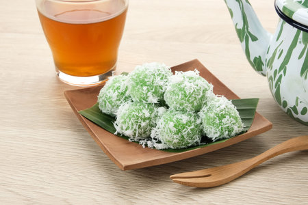 Klepon, Indonesian traditional snack, made from glutinous rice flour formed into small balls and filled with brown sugar. Finally covered with grated coconut.の写真素材