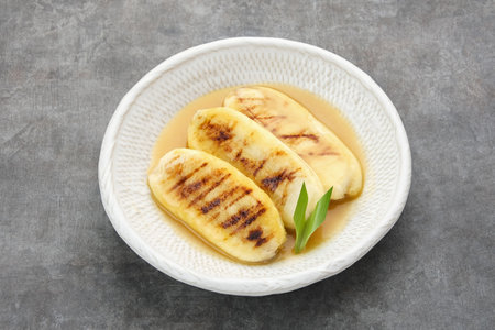 Pisang Gapit or Pisang Epe, grilled banana with palm sugar sauce. Indonesian traditional food.の写真素材