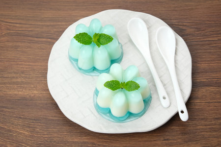 Silky sweet lychee pudding topped with mint leaves.の写真素材