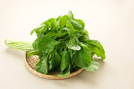 Bunch of raw fresh spinach leaves on wooden table