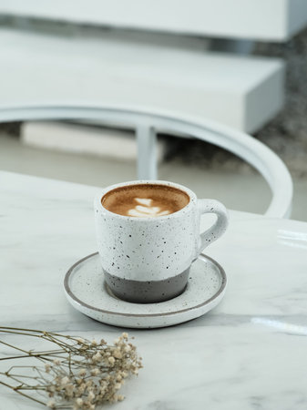 A cup of hot latte coffee on the table for breakfastの写真素材