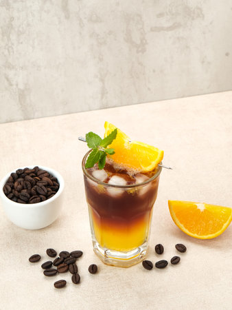 Iced americano black coffee and layer of orange juice
