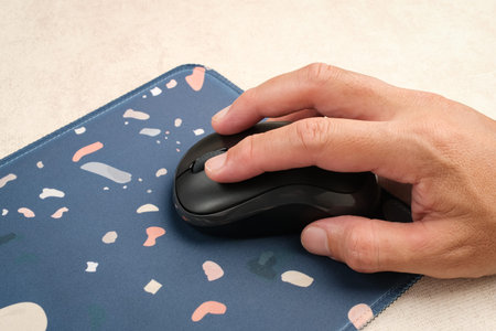 Hand using wireless computer mouse