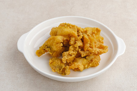 Fillet Ikan Telur Asin. Crispy fried fish fillet covered with salted egg sauce. Indonesian foodの写真素材