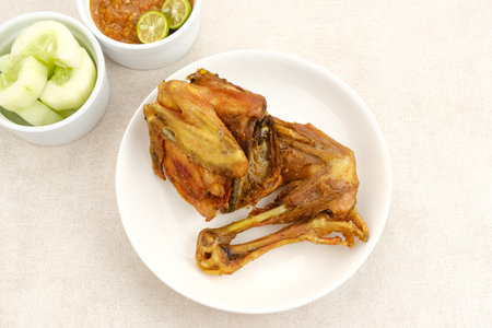 Ayam Goreng or Fried Chicken with sambal and cucumber, Indonesian foodの写真素材