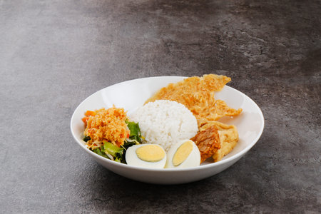 Nasi Gudangan, rice served with various vegetable with grated coconut seasoned and various side...