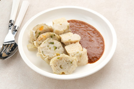 Siomay Bandung or Shumay or steamed dumplings with boiled tofu. Indonesian traditional street food with peanut sauce.の写真素材