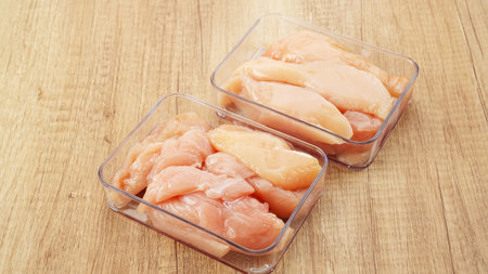 Fresh chicken breast fillet on freezer storage boxの写真素材