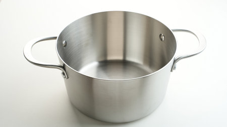 Empty stainless pan isolated on white backgroundの写真素材