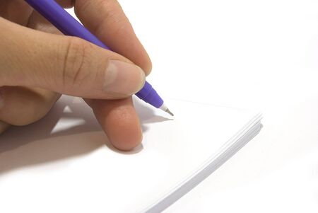 The human hand holds a pen, is ready to the letter の写真素材