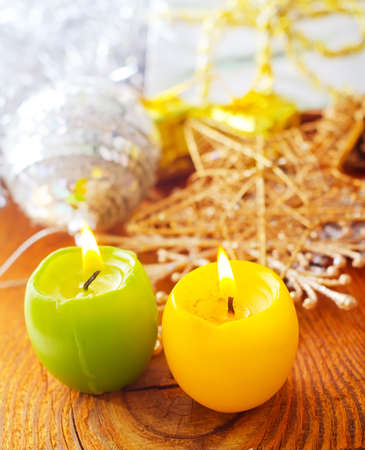 two candles, yellow and green candles, cristmas decorationの写真素材