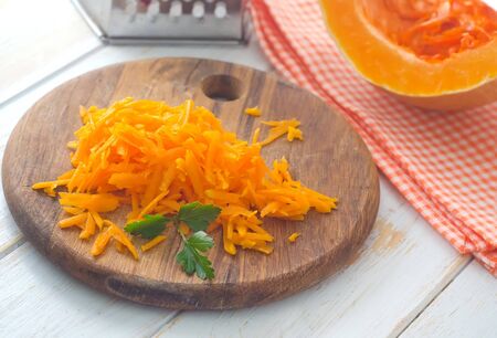 Pumpkin on the wooden board, raw pumpkinの写真素材