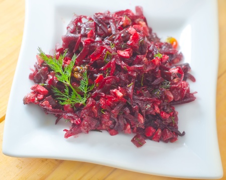 Fresh salad with beet and walnuts on white plateの写真素材
