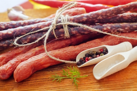 sausages on the wooden table with aroma spiceの写真素材