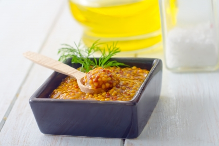 Mustard in the black bowl on tableの写真素材