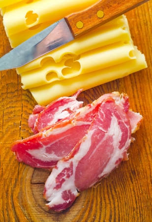 Bacon with cheese on the wooden boardの写真素材