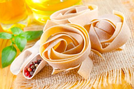 Raw pasta with aroma spice and basilの写真素材