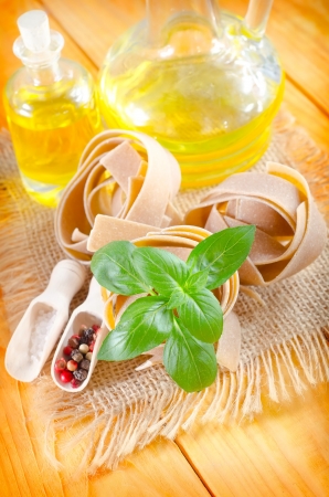Raw pasta with aroma spice and basilの写真素材