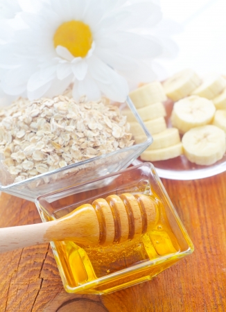 Honey in the glass bowl on the wooden tableの写真素材
