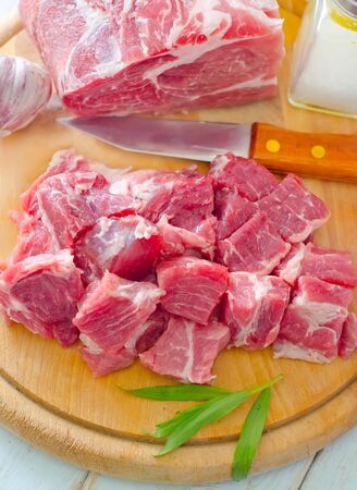 raw meat and knife on the wooden boardの写真素材