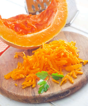Pumpkin on the wooden board, raw pumpkinの写真素材