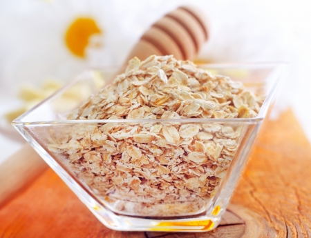 Raw oat flaks in the glass bowlの写真素材