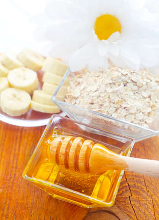 Honey in the glass bowl on the wooden tableの写真素材