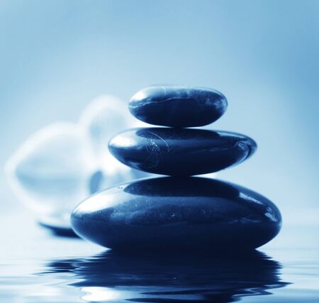 Orchid and black basalt for spa on green backgroundの写真素材
