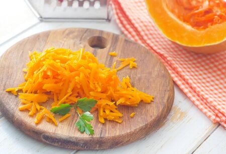 Pumpkin on the wooden board, raw pumpkinの写真素材
