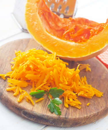 Pumpkin on the wooden board, raw pumpkinの写真素材
