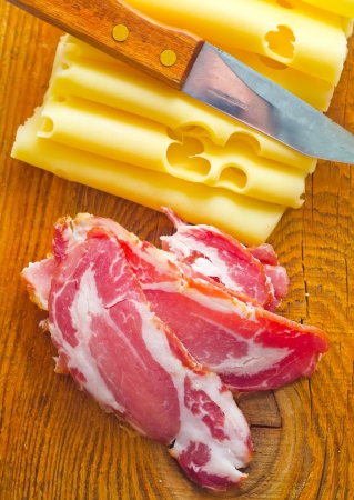 Bacon with cheese on the wooden boardの写真素材