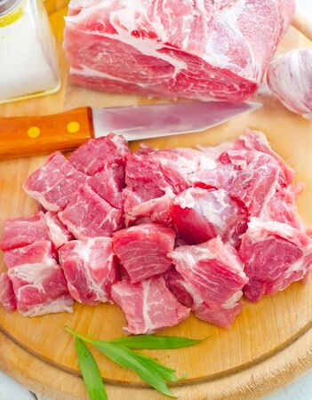 raw meat and knife on the wooden boardの写真素材
