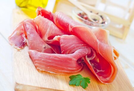 Proscuitto on a wooden boardの写真素材