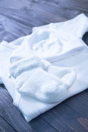 baby clothes on a tableの写真素材