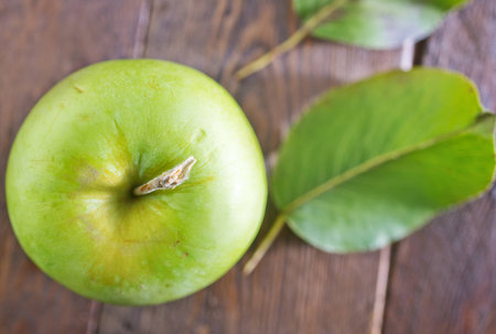 fresh and green apple on the wooden tableの写真素材