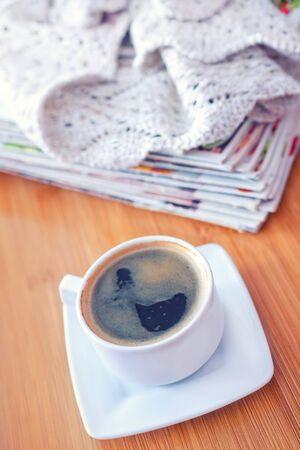 coffee and stack of magazins on wooden trayの写真素材