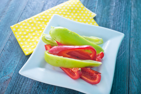 color pepper on the plate and on a table