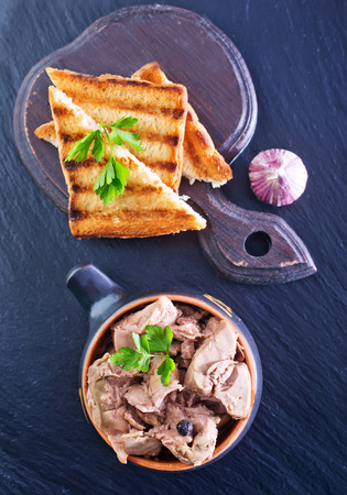 liver of cod in the glass bank and on a tableの写真素材