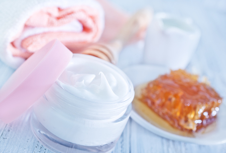 body lotion in glass bank and on a tableの写真素材